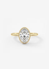 Vintage inspired oval bezel set Frank Darling diamond engagement ring with millgrain detailing and a low profile trellis basket in yellow gold