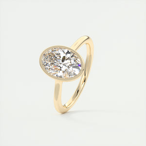 Vintage inspired oval bezel set Frank Darling diamond engagement ring with millgrain detailing and a low profile trellis basket in yellow gold