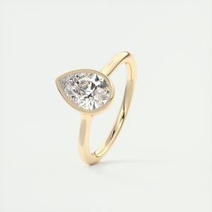 Vintage inspired pear bezel set Frank Darling diamond engagement ring with millgrain detailing and a low profile trellis basket in yellow gold