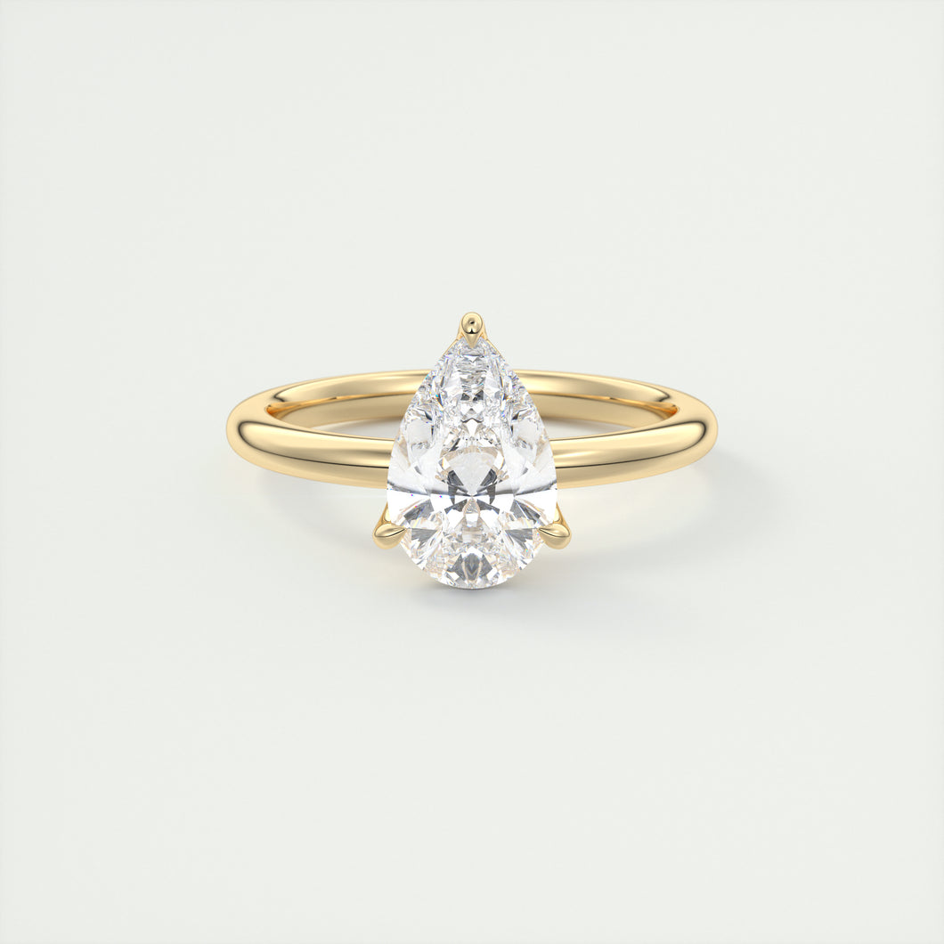 Pear cut solitaire Frank Darling lab grown diamond engagement ring with floral prongs, low profile basket and 1.8mm round band in yellow gold
