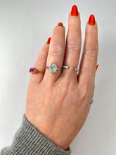 Billie bathtub oval solitaire diamond bezel set engagement ring in platinum on hand